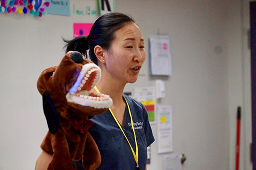 Parents - Volunteer Discussing Career as Periodontist and Caring for Teeth